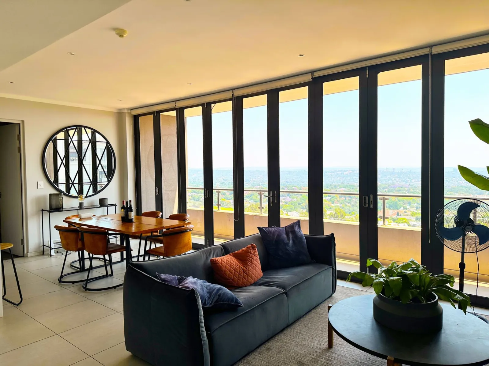 Contemporary living room with large windows offering a stunning cityscape view.